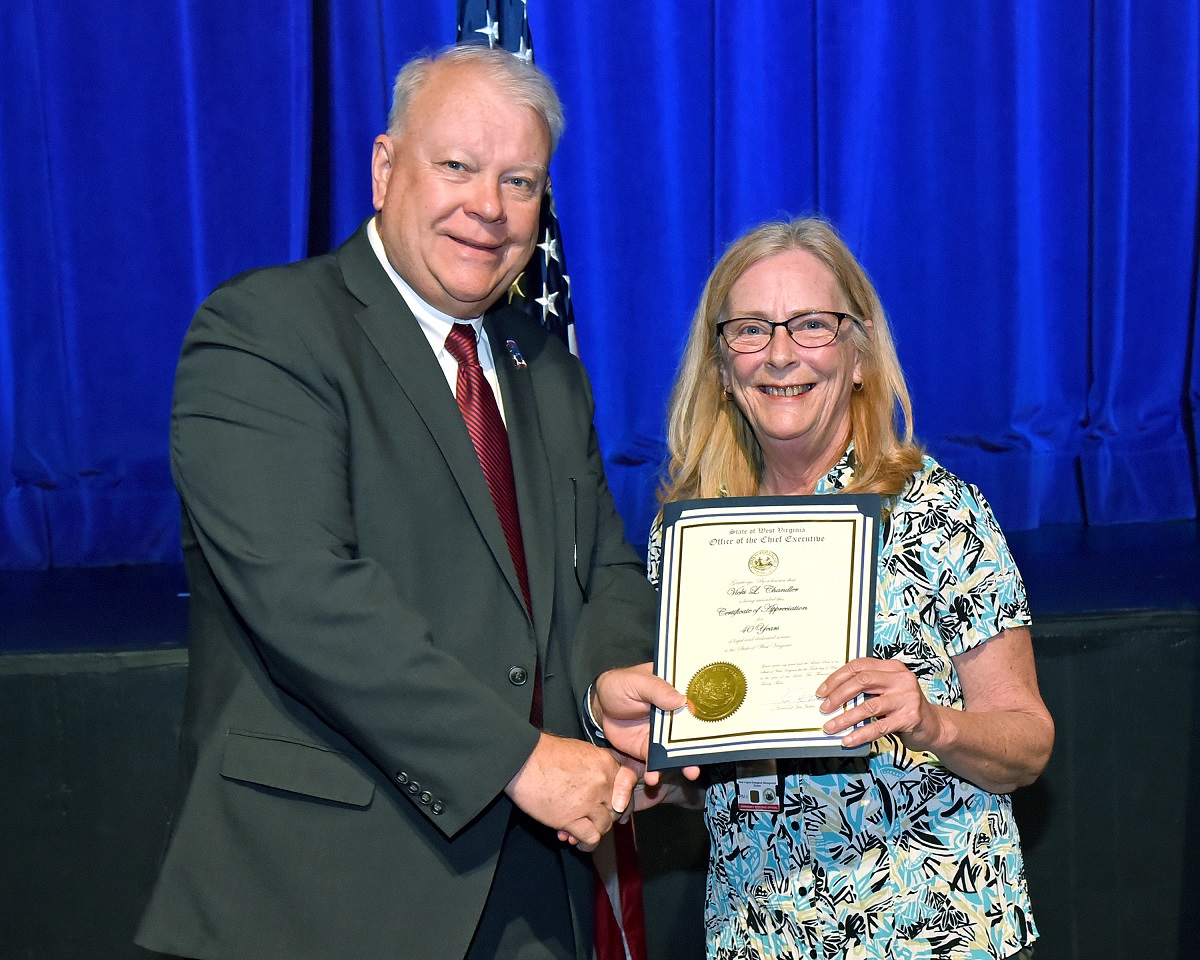 Vicki Chandler receives a certificate of recognition from West Virginia Department of Homeland Security Secretary Jeff Sandy for